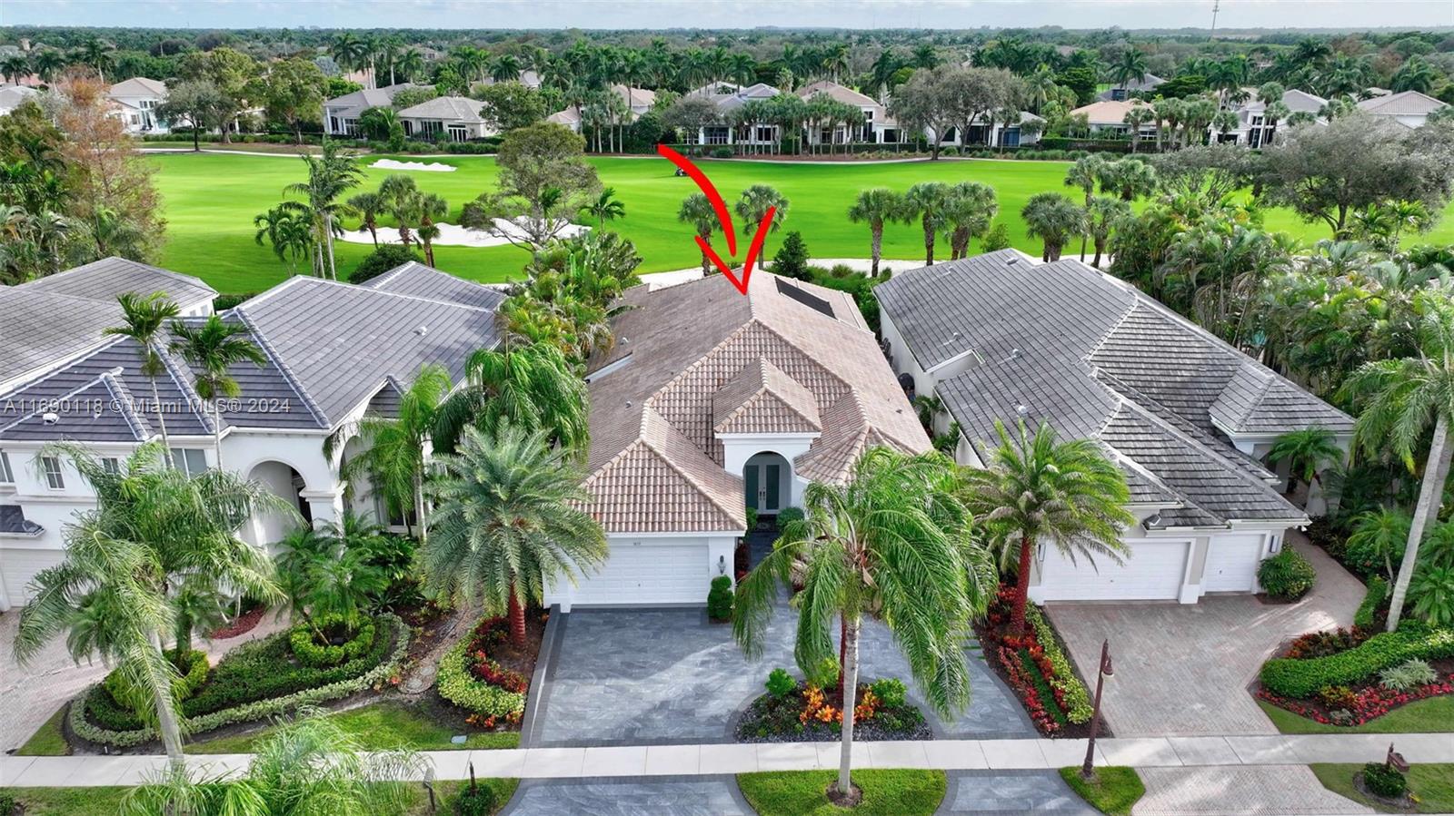 an aerial view of a house with outdoor space and lake view in back