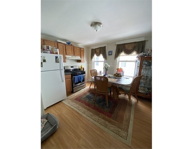 a living room with stainless steel appliances furniture and a dining table