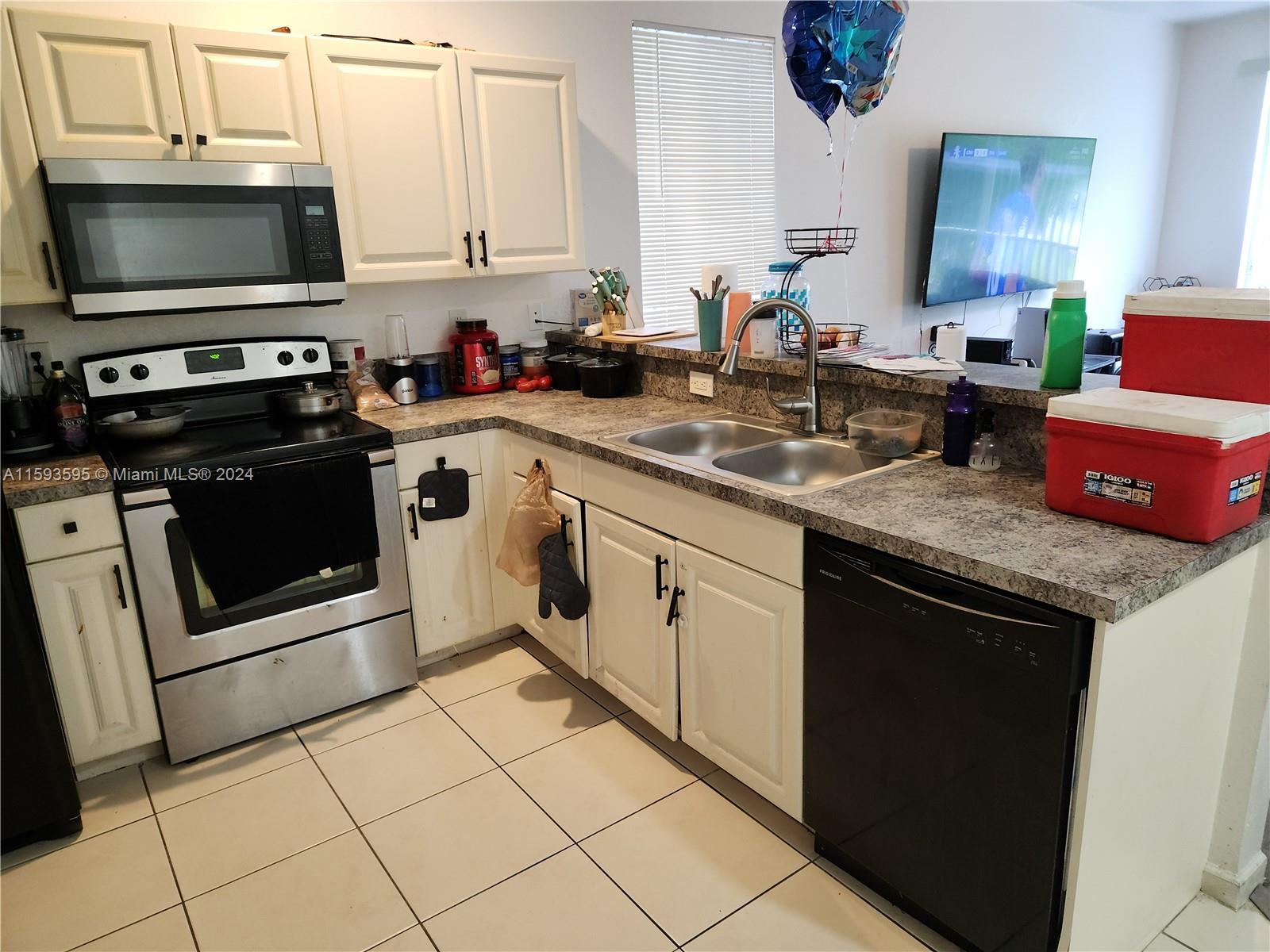 a kitchen with stainless steel appliances granite countertop a sink stove and microwave