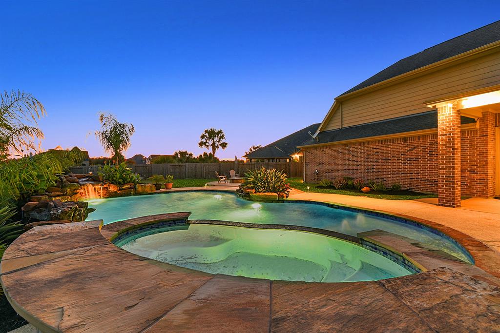 a view of a swimming pool with a yard