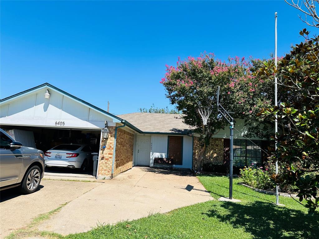 a view of a car park in front of house