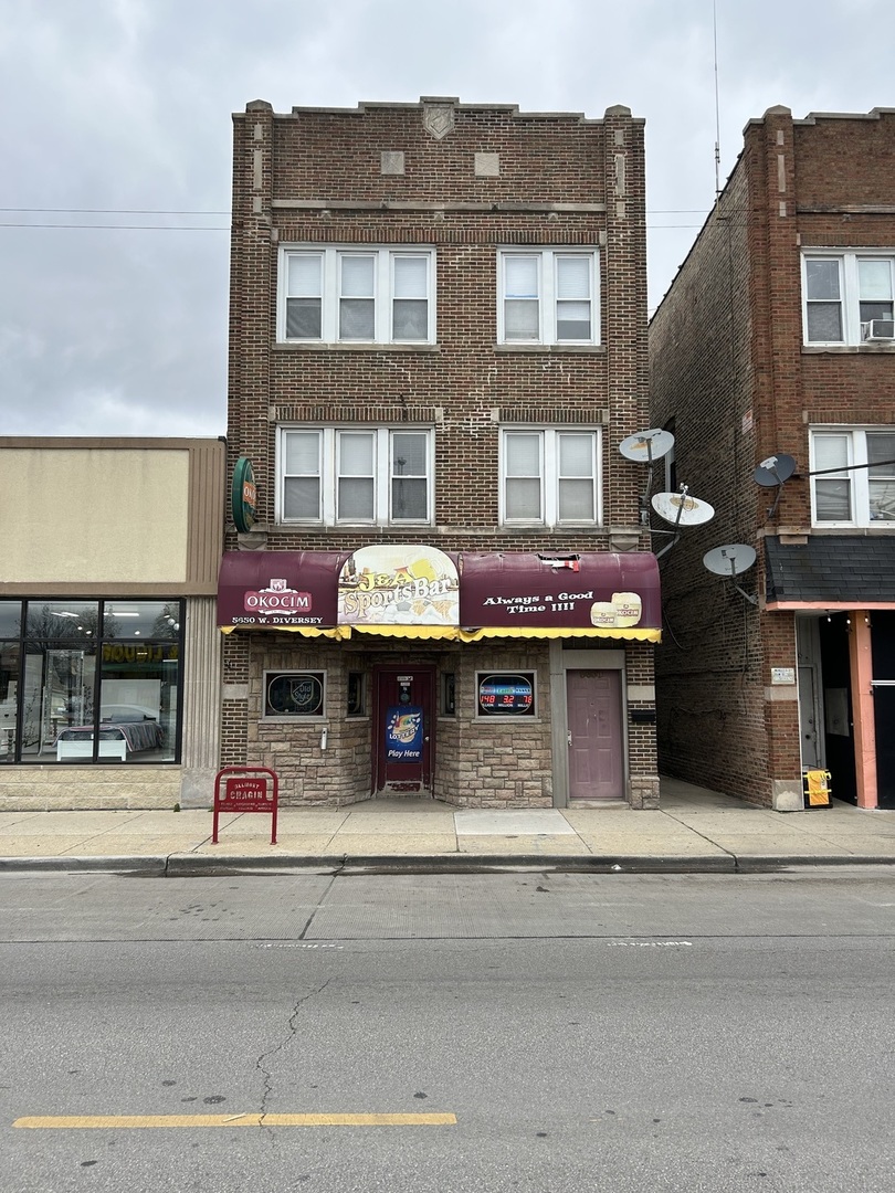 front view of a brick building with a retail shops