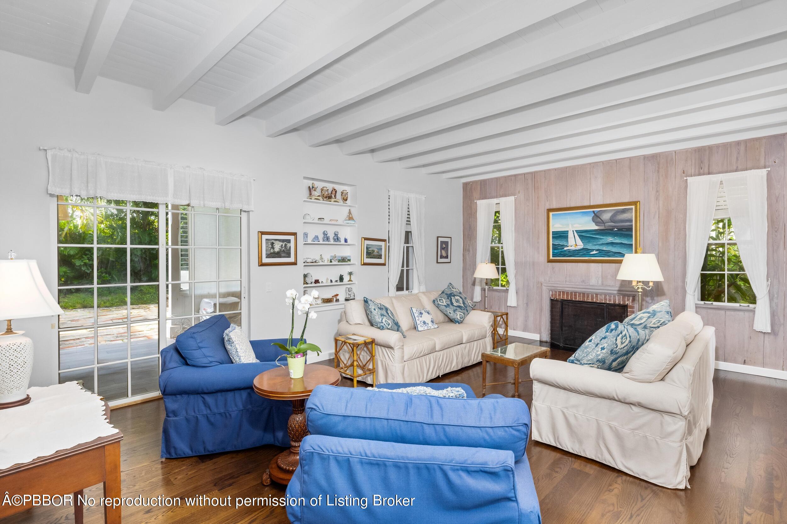 a living room with furniture large window and fireplace