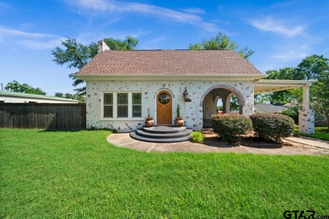 a front view of a house with garden