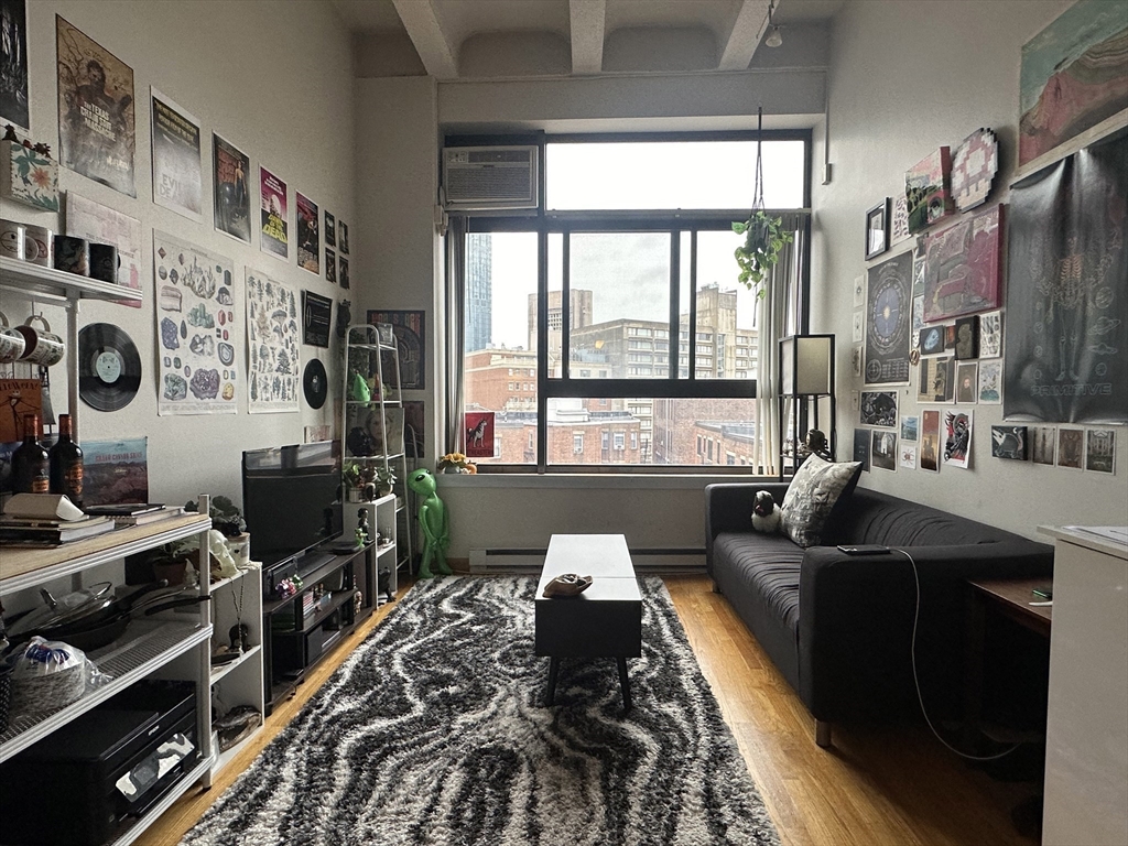 a living room with furniture and a floor to ceiling window