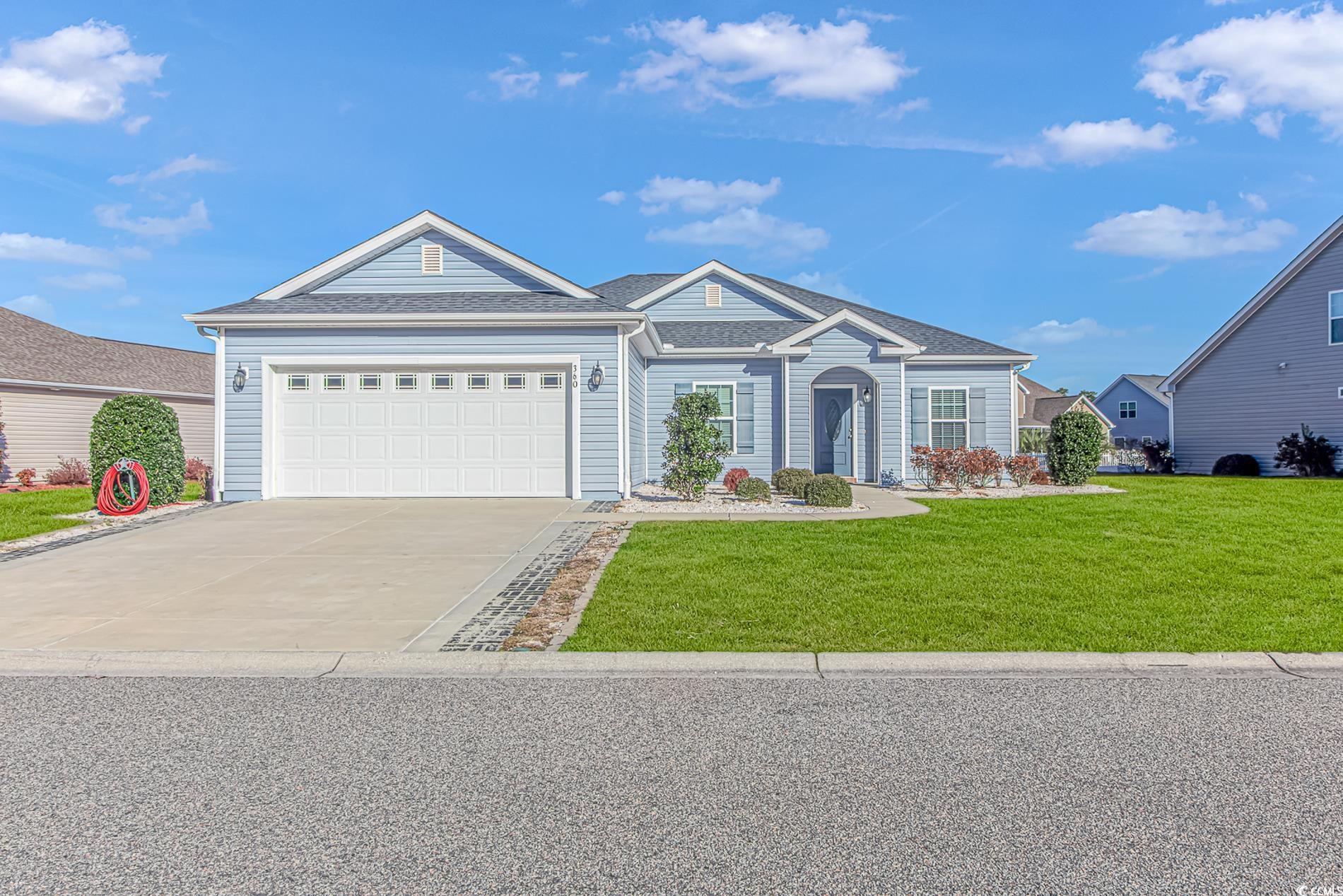 Single story home featuring a garage and a front l