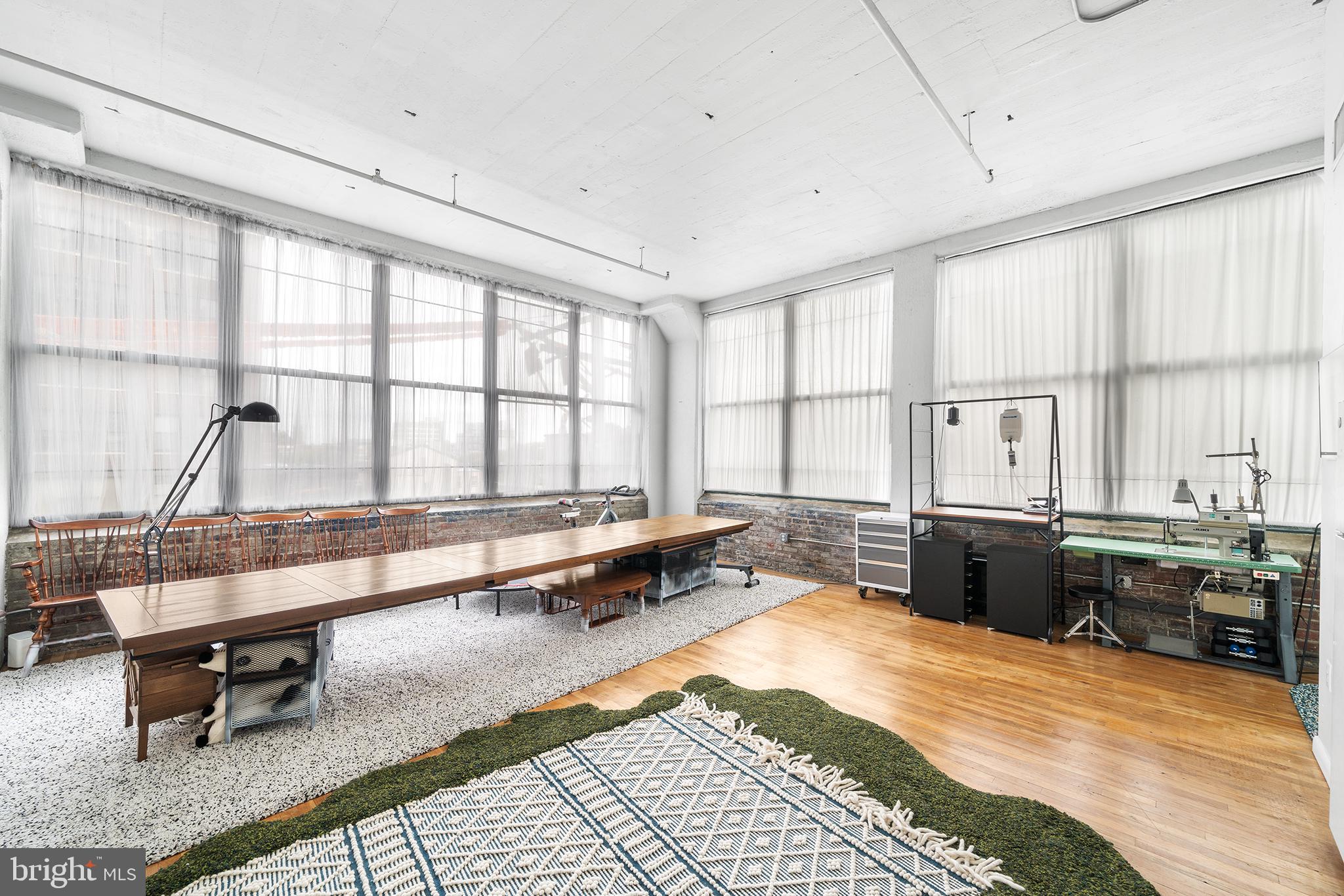 a large room with a large window and table in it