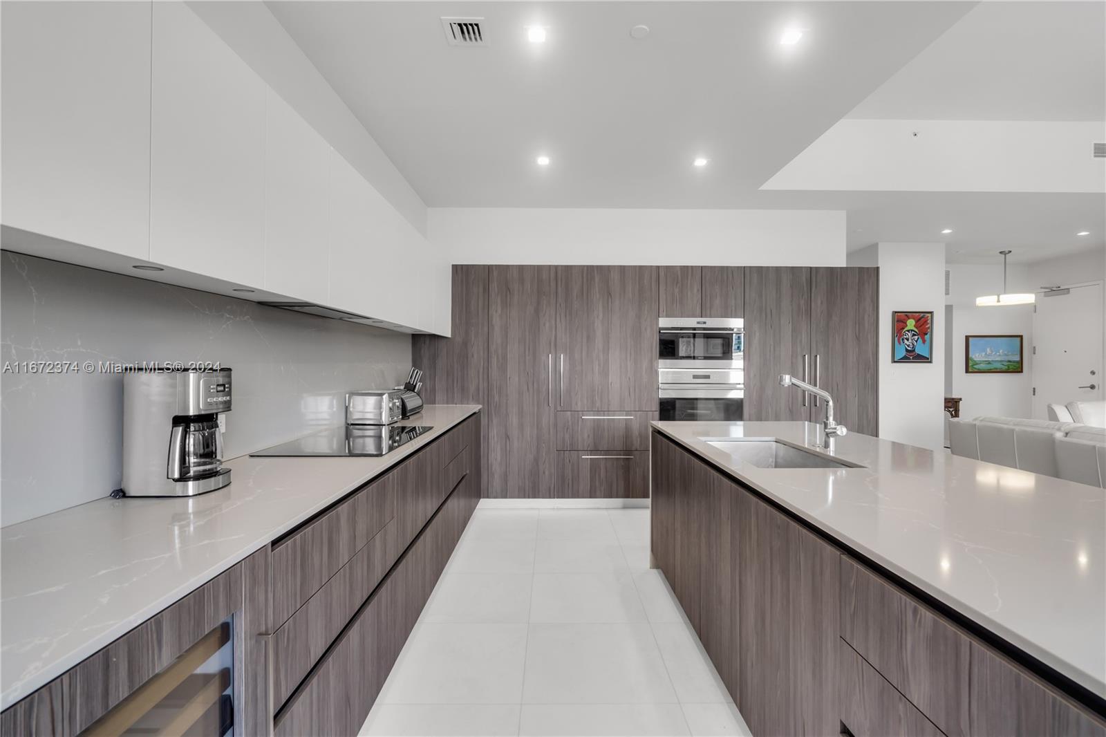 a large kitchen with stainless steel appliances lots of counter space and a sink