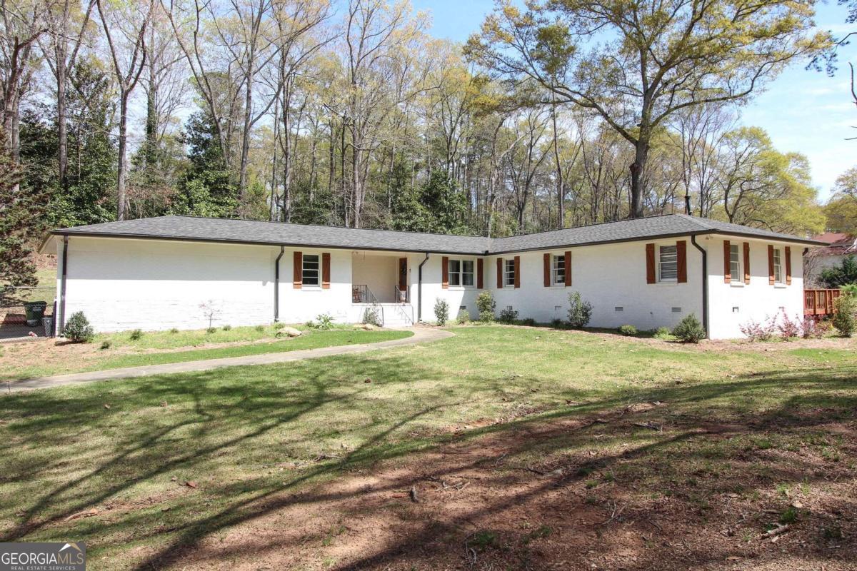 a front view of a house with a garden