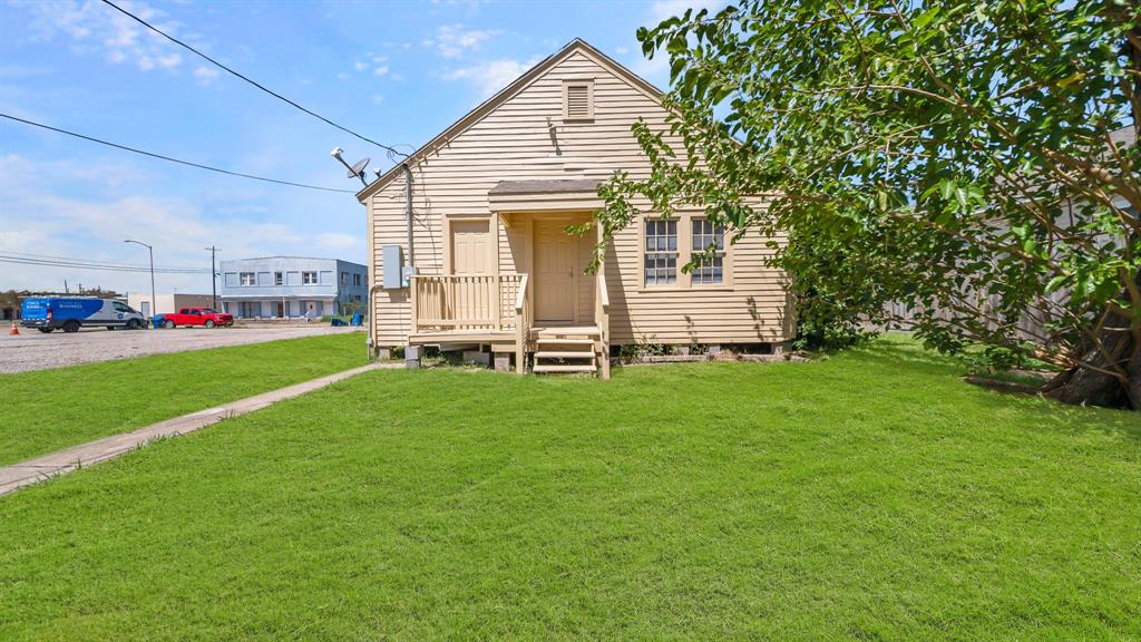 a front view of a house with a garden and yard