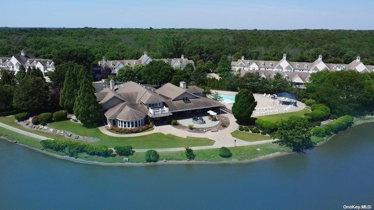 a view of a house with a garden and lake view