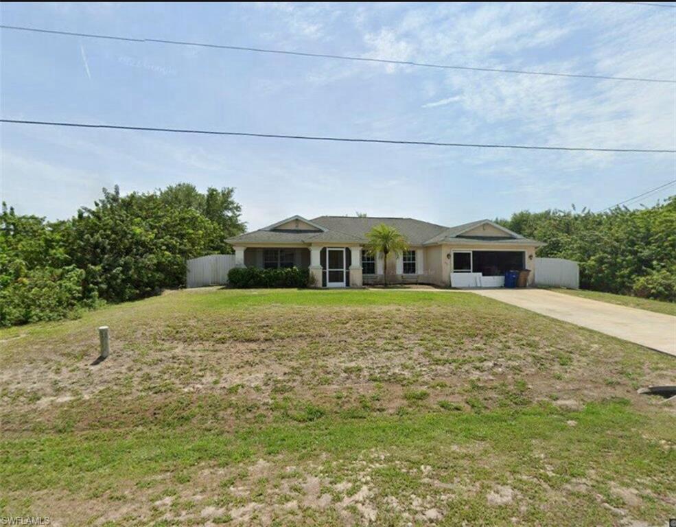 Ranch-style home featuring a front yard