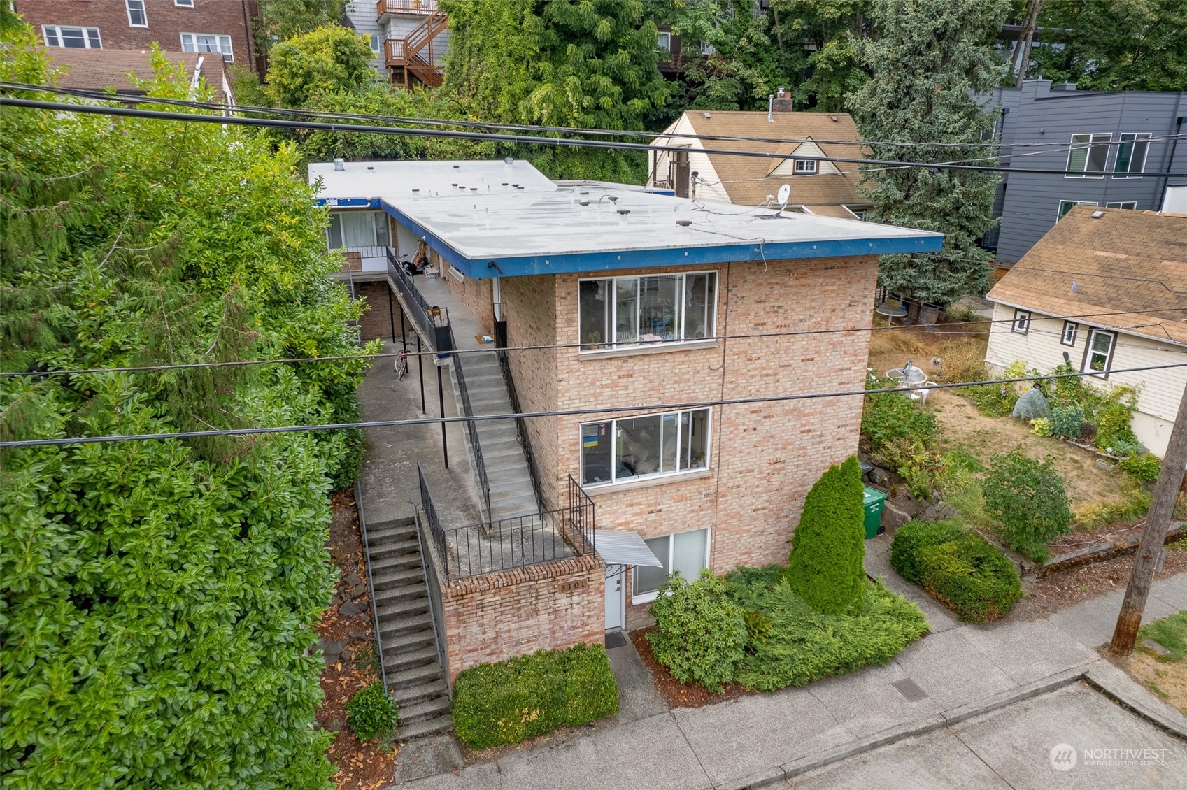 an aerial view of a house with a yard and potted plants