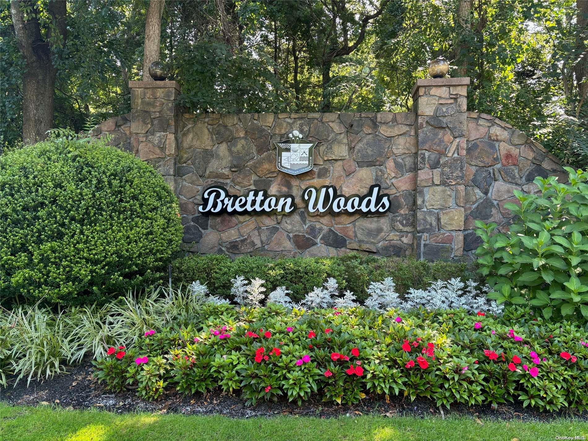 a view of sign board and covered in white flowers