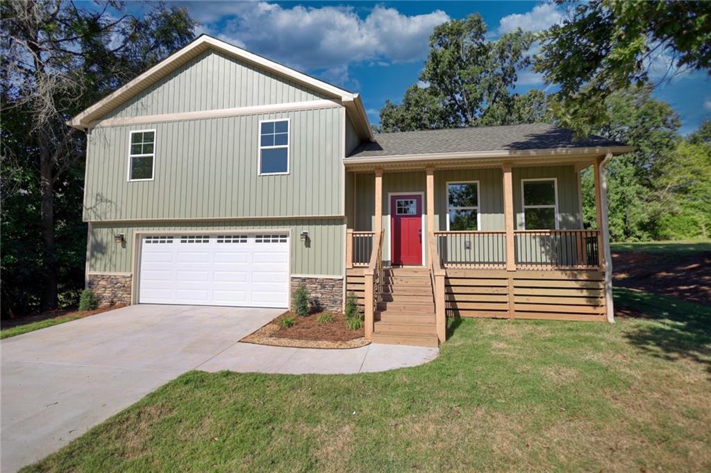 a front view of a house with a yard and garage