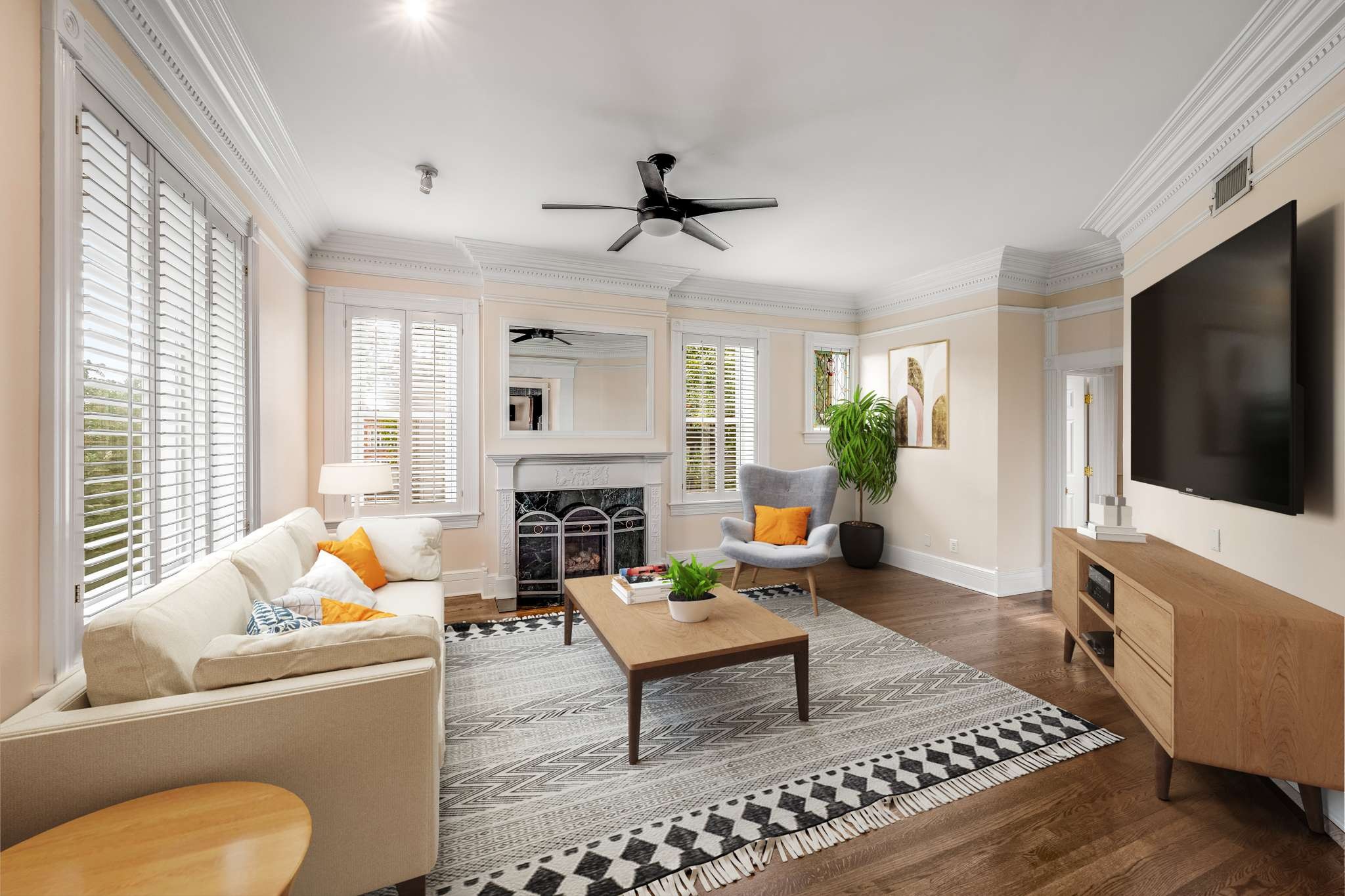 a living room with furniture a flat screen tv and a fireplace