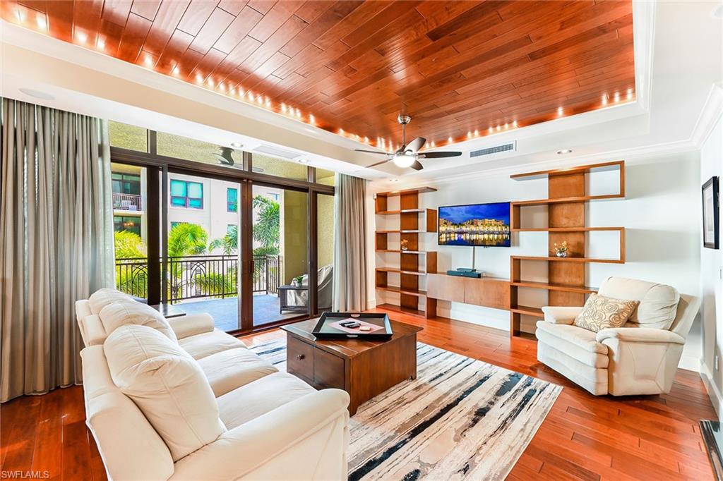 a living room with furniture and a floor to ceiling window