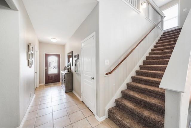 a view of a hallway with entryway and stairs