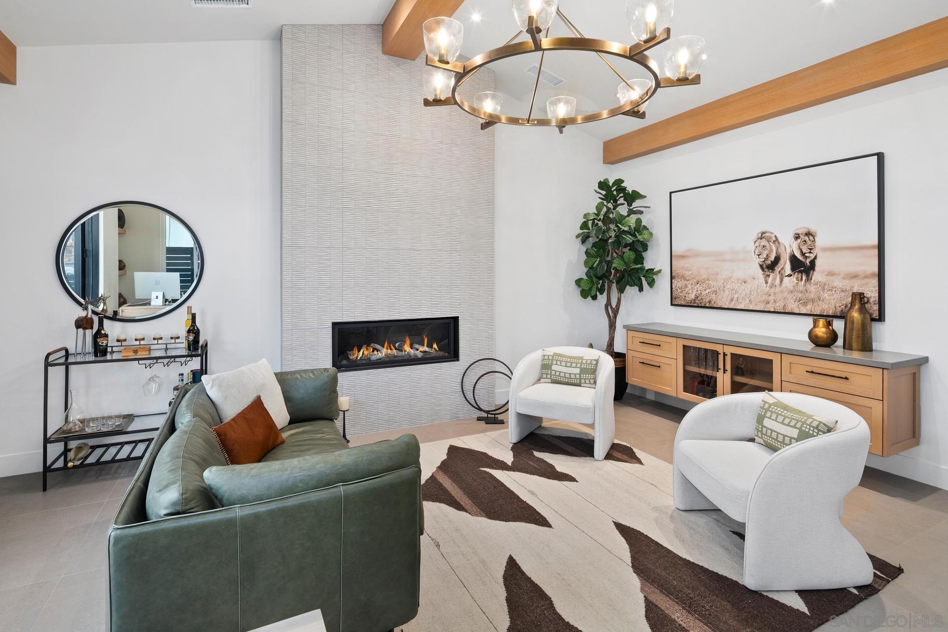 a living room with furniture a chandelier and a mirror