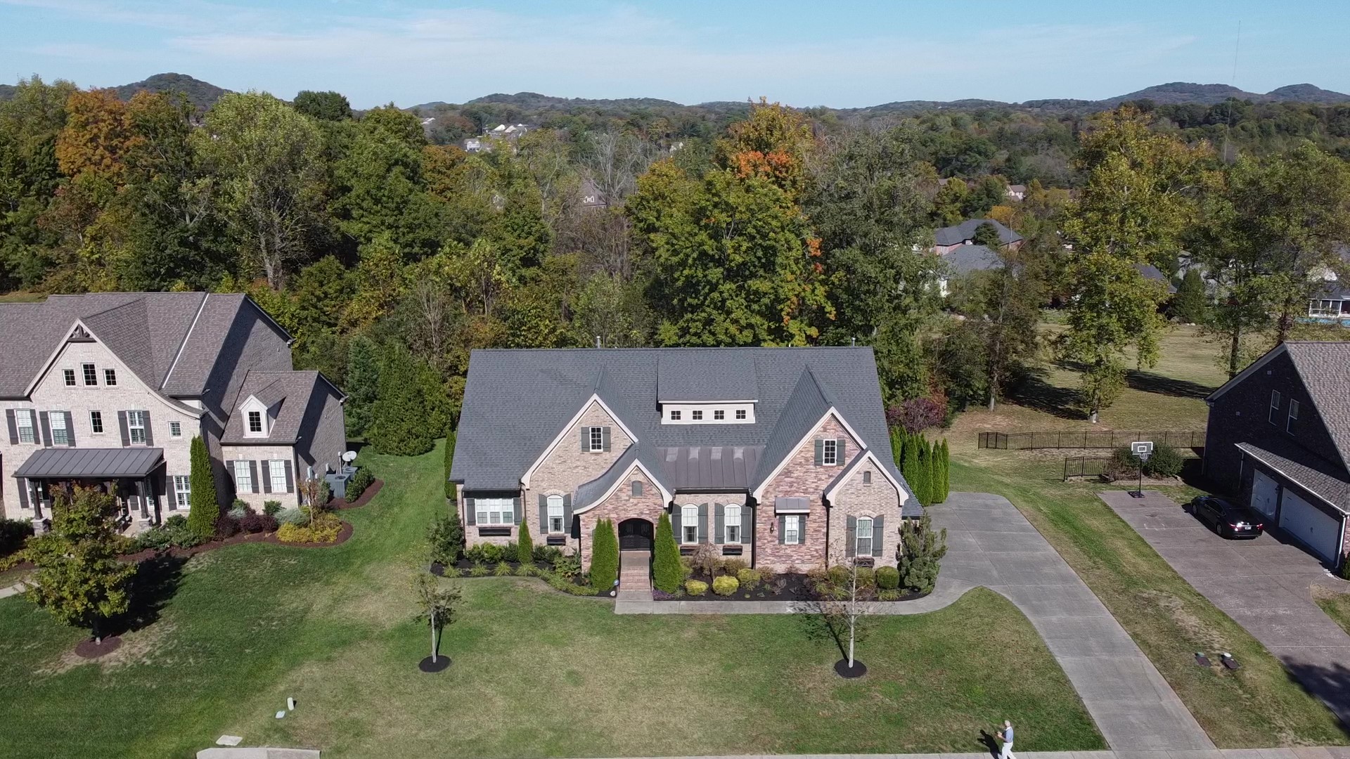 an aerial view of a house with a garden and trees