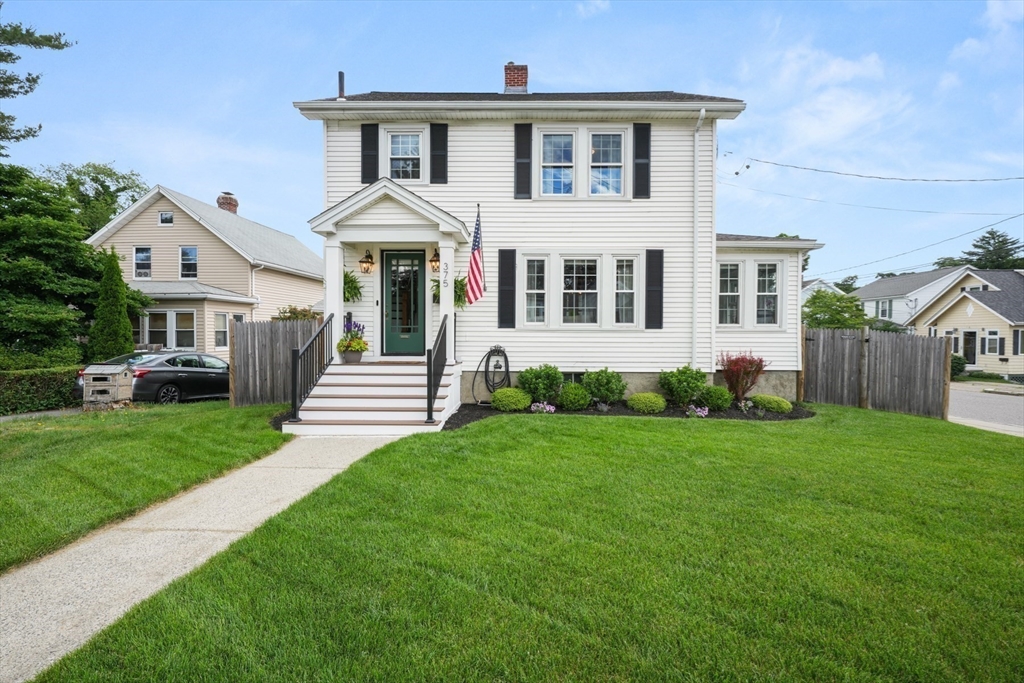 a front view of a house with a garden