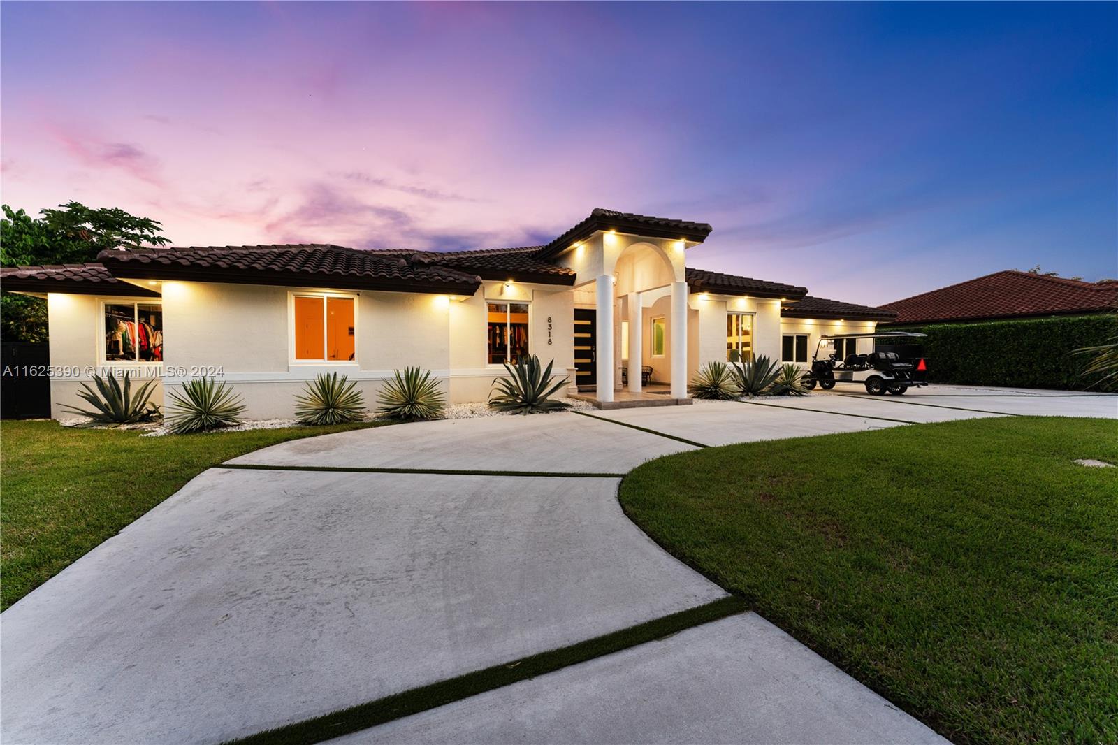 a front view of a house with a yard and a garage