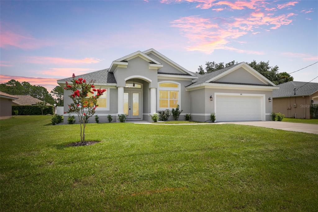 a front view of a house with a yard