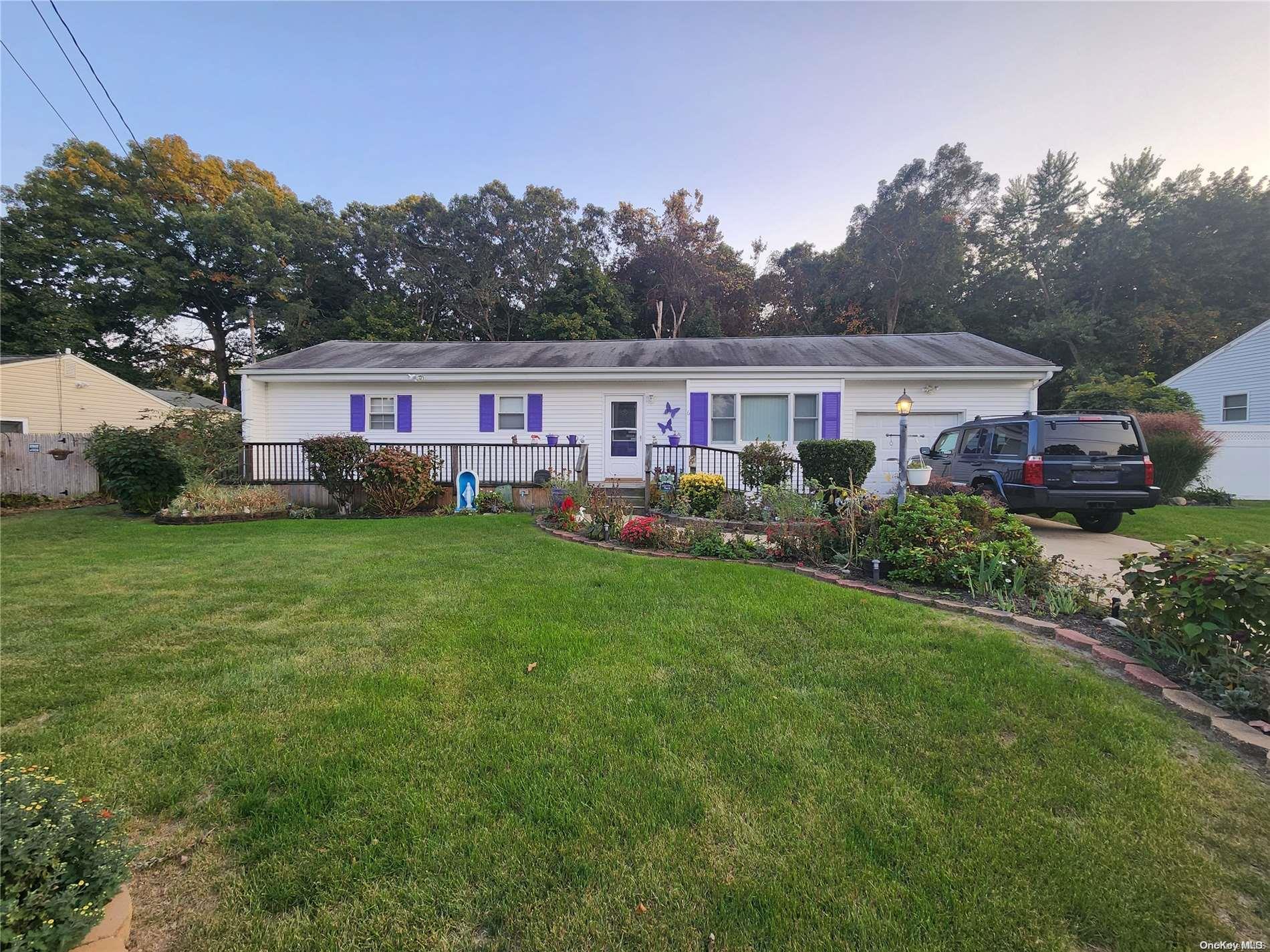 a view of a house with a big yard and large trees