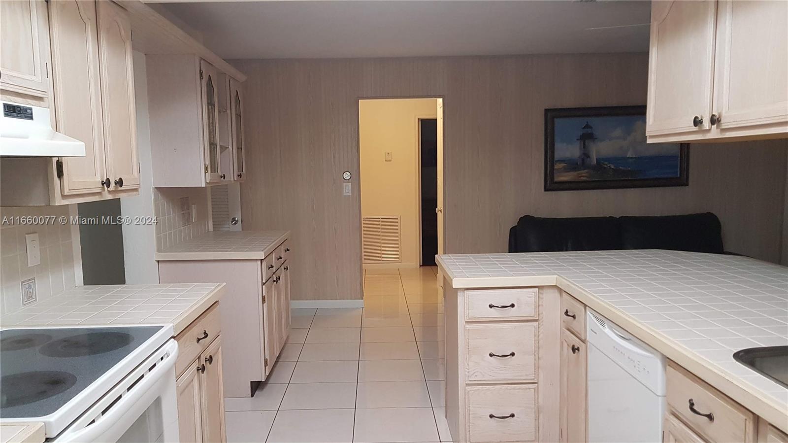 a kitchen with a refrigerator and a sink