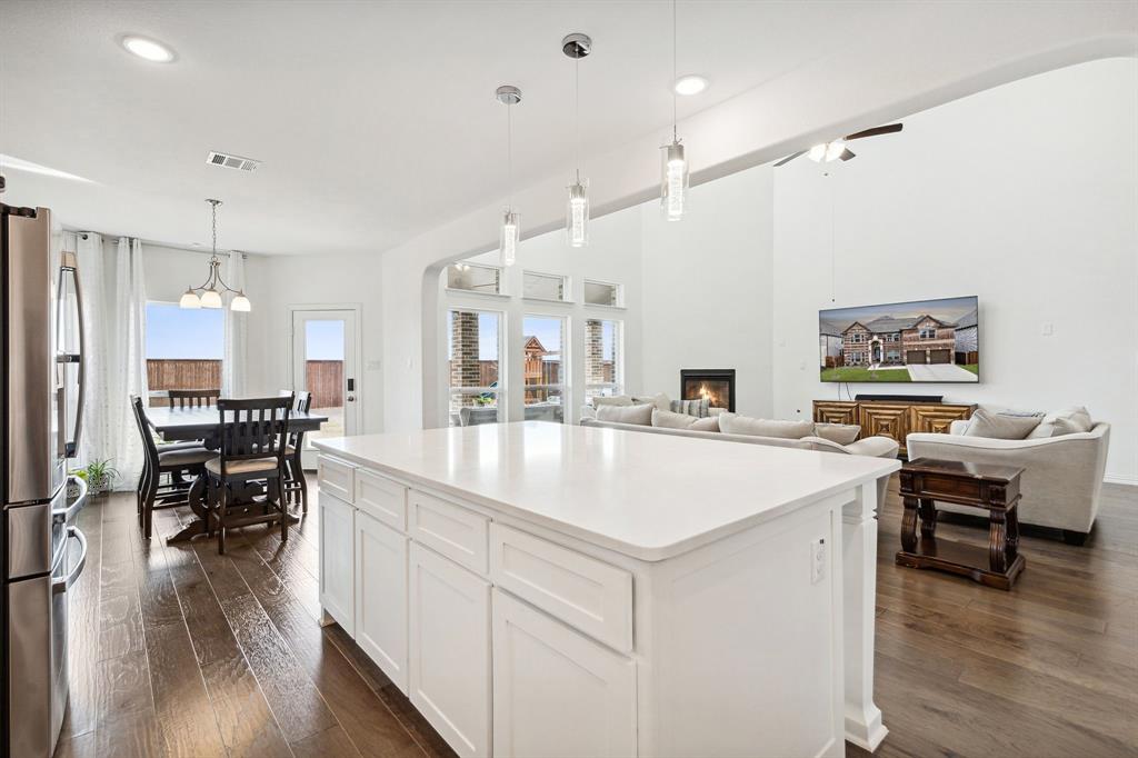 a large white kitchen with a table and chairs