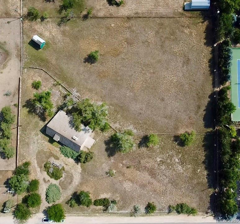 an aerial view of a house with a yard