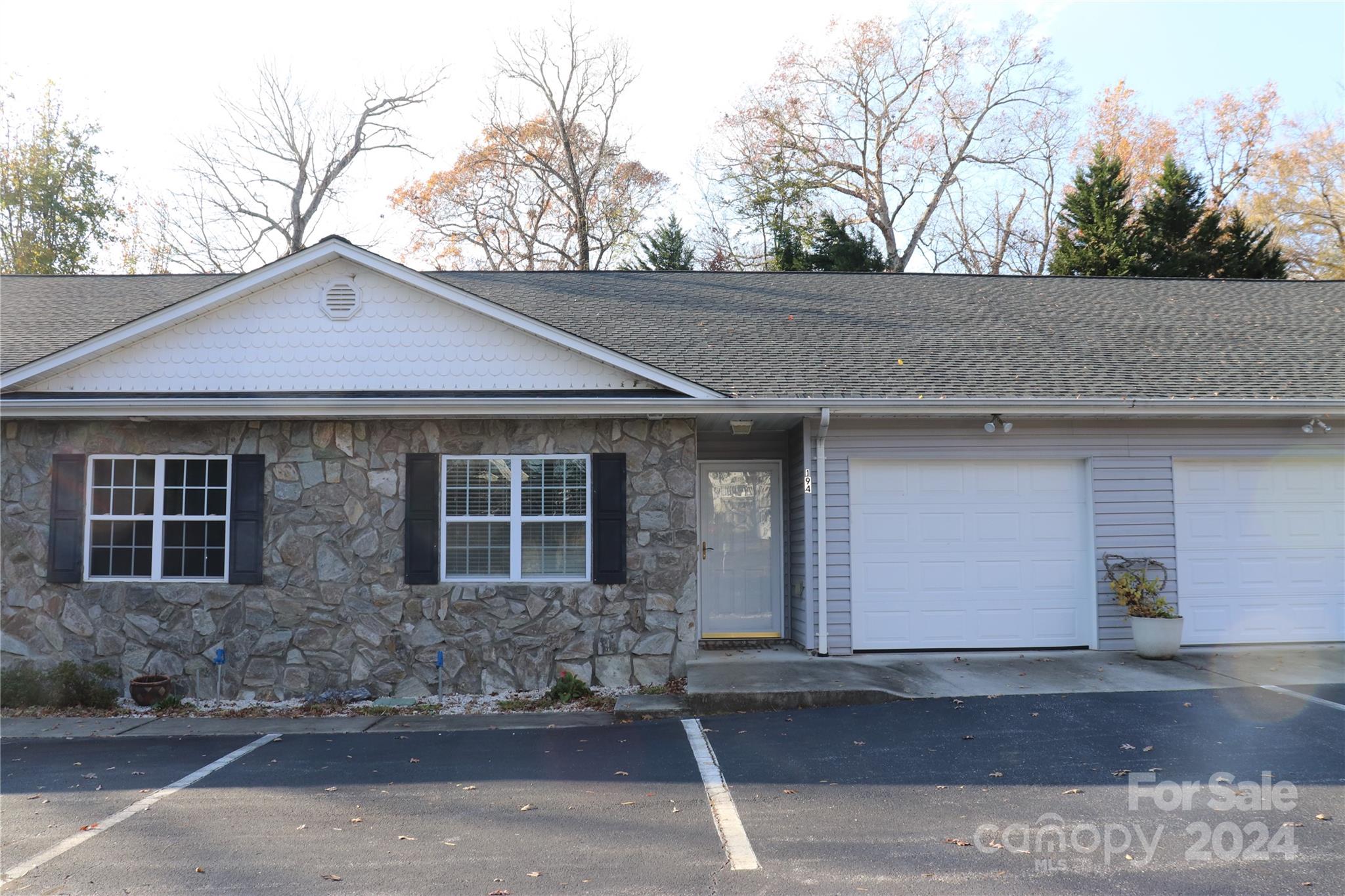 a front view of a house with yard and trees