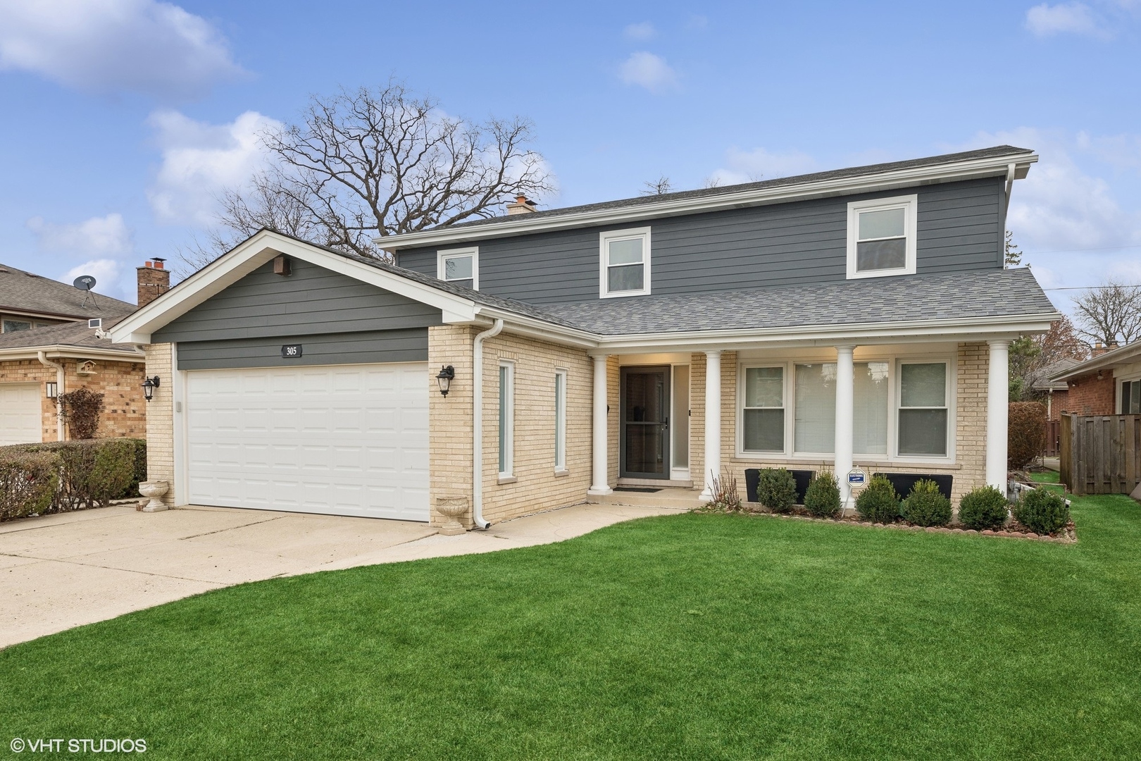 a front view of a house with a yard and garage