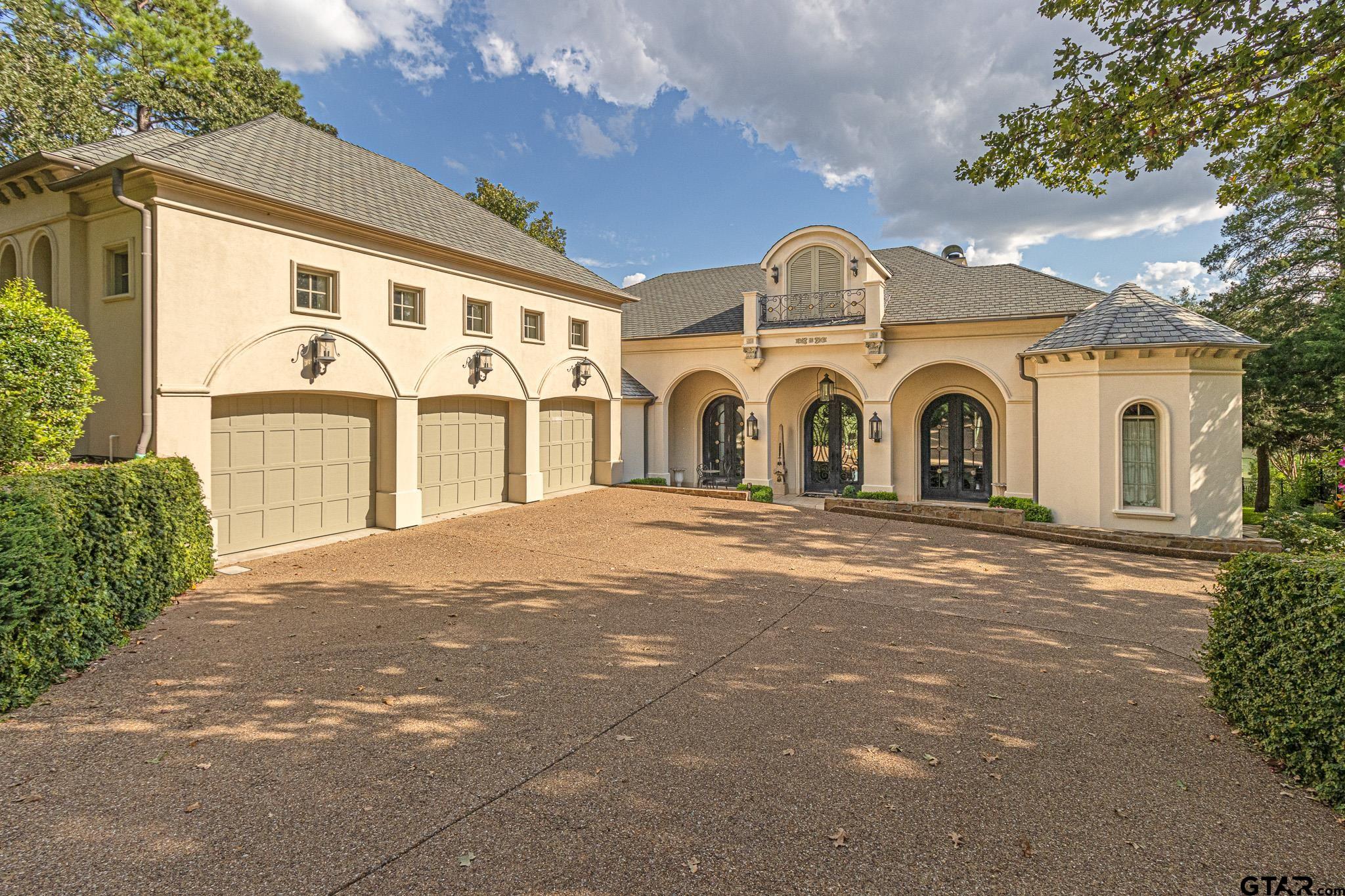 a view of a grey house with a outdoor space