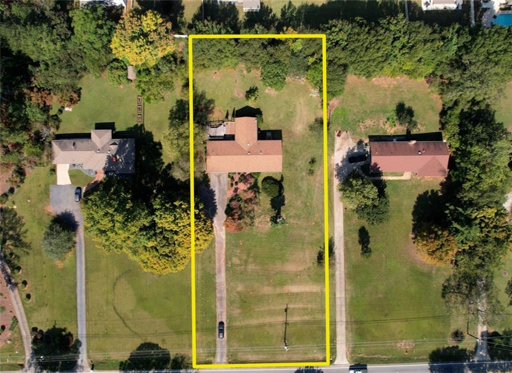 an aerial view of a residential houses with outdoor space