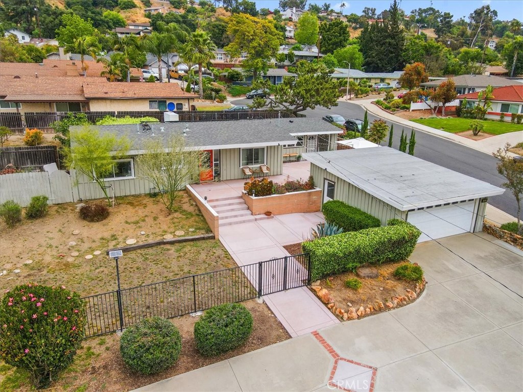 an aerial view of a house with a garden and lots of trees