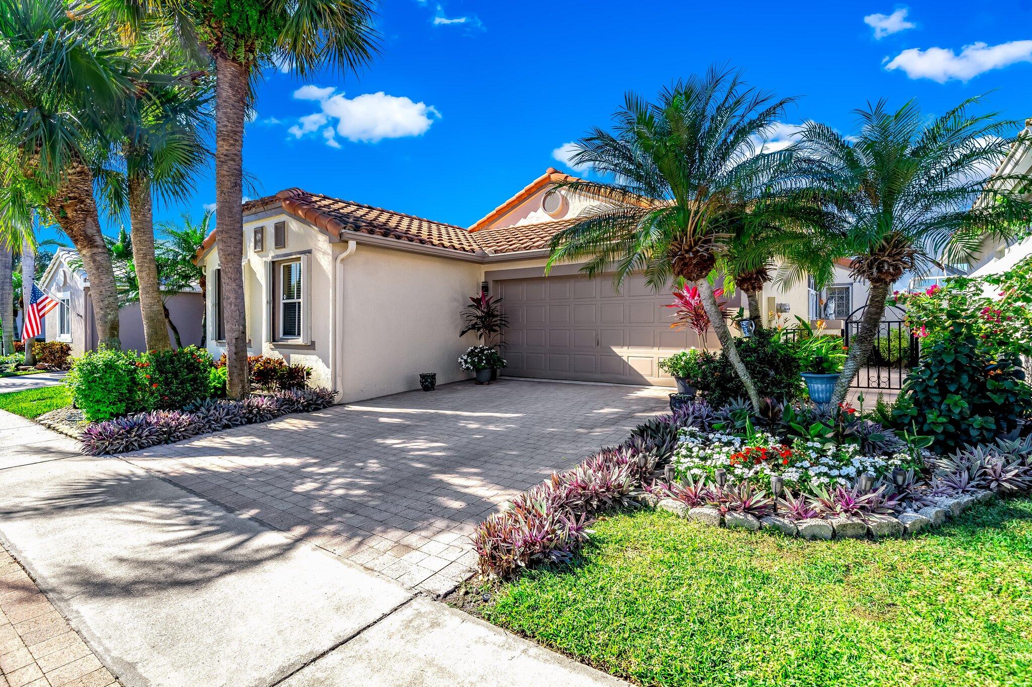 a front view of a house with a yard and a garage