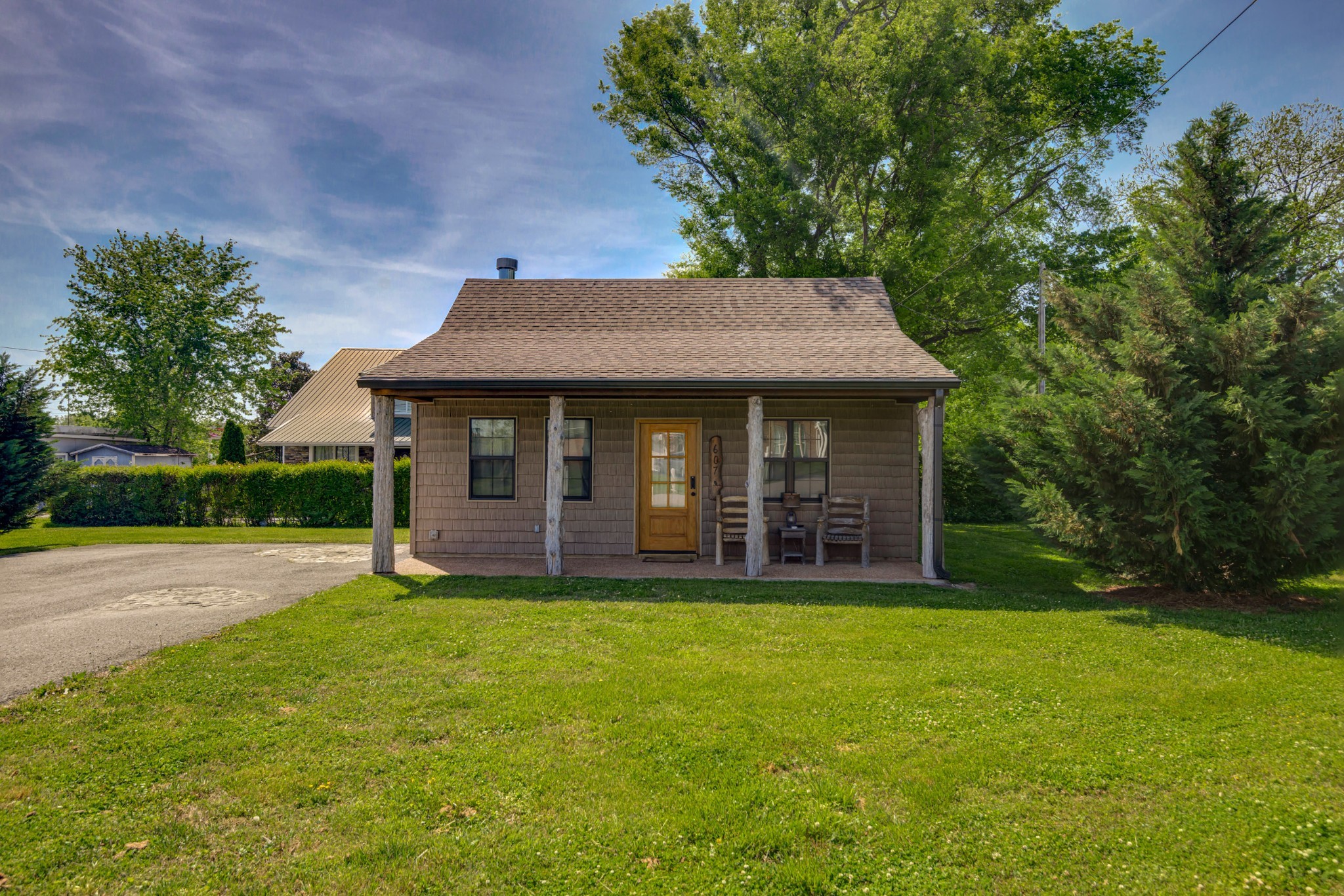 a view of a house with a yard and sitting area