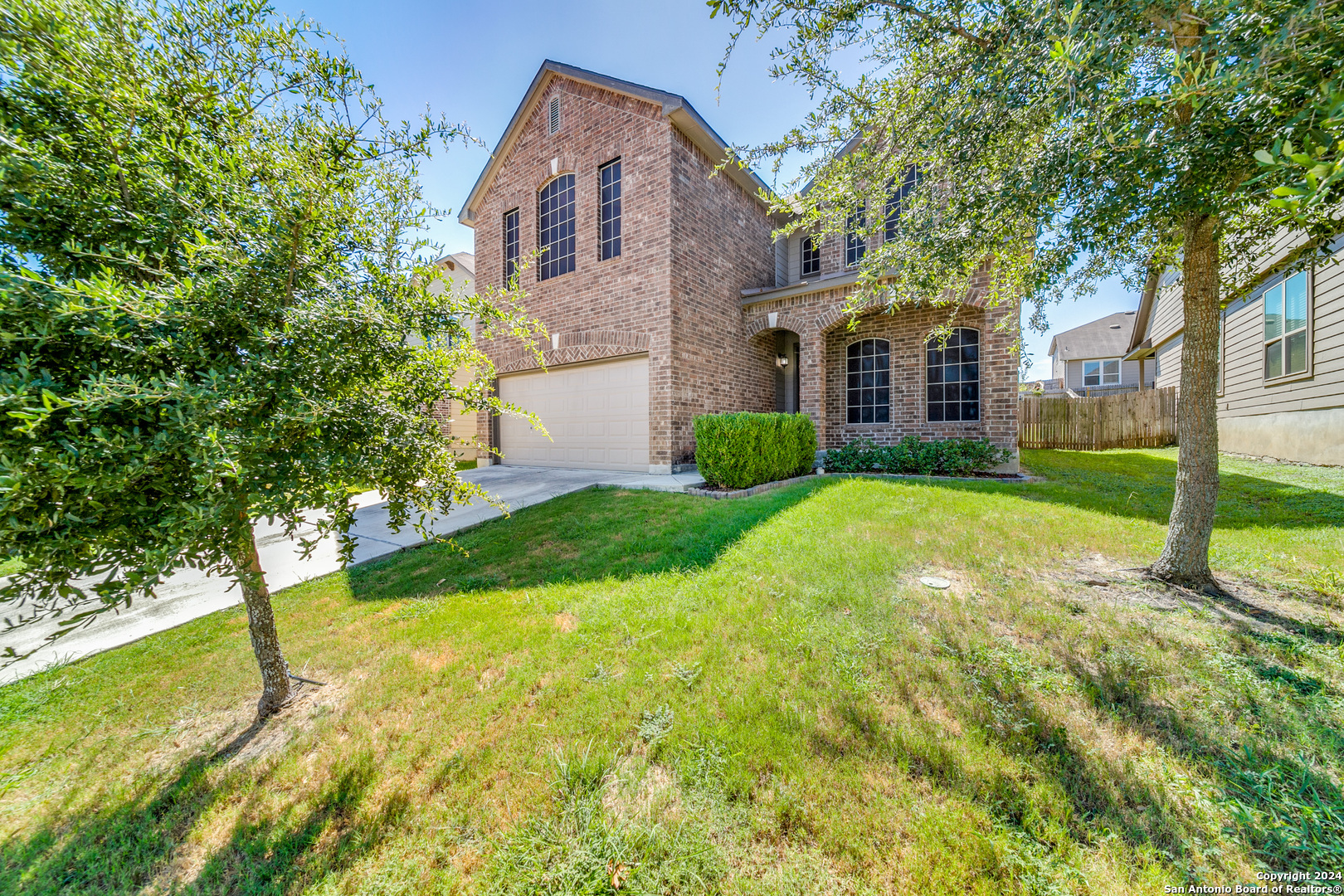 a view of a house with yard and tree s