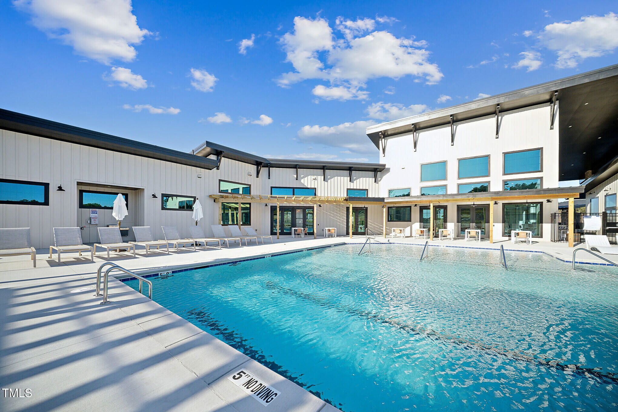 a swimming pool with outdoor seating and yard