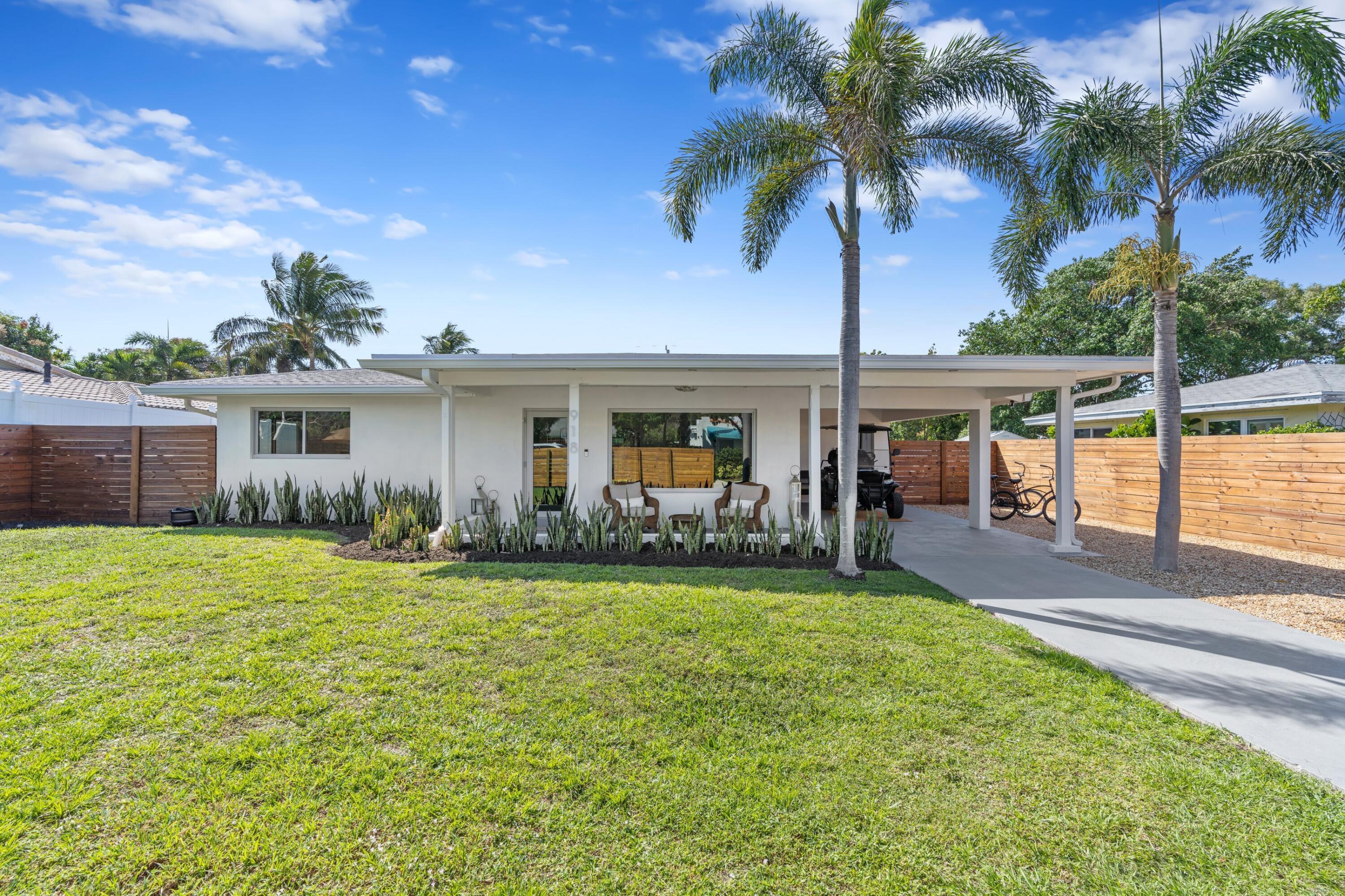 a front view of house with yard and outdoor seating