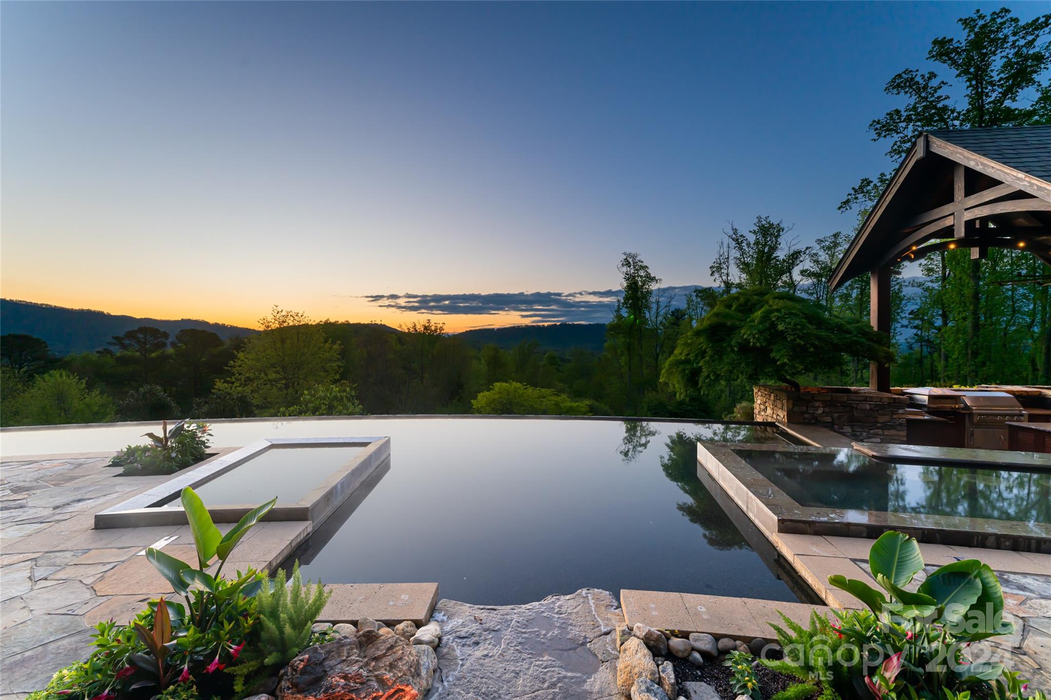 a view of a swimming pool with a patio and a yard