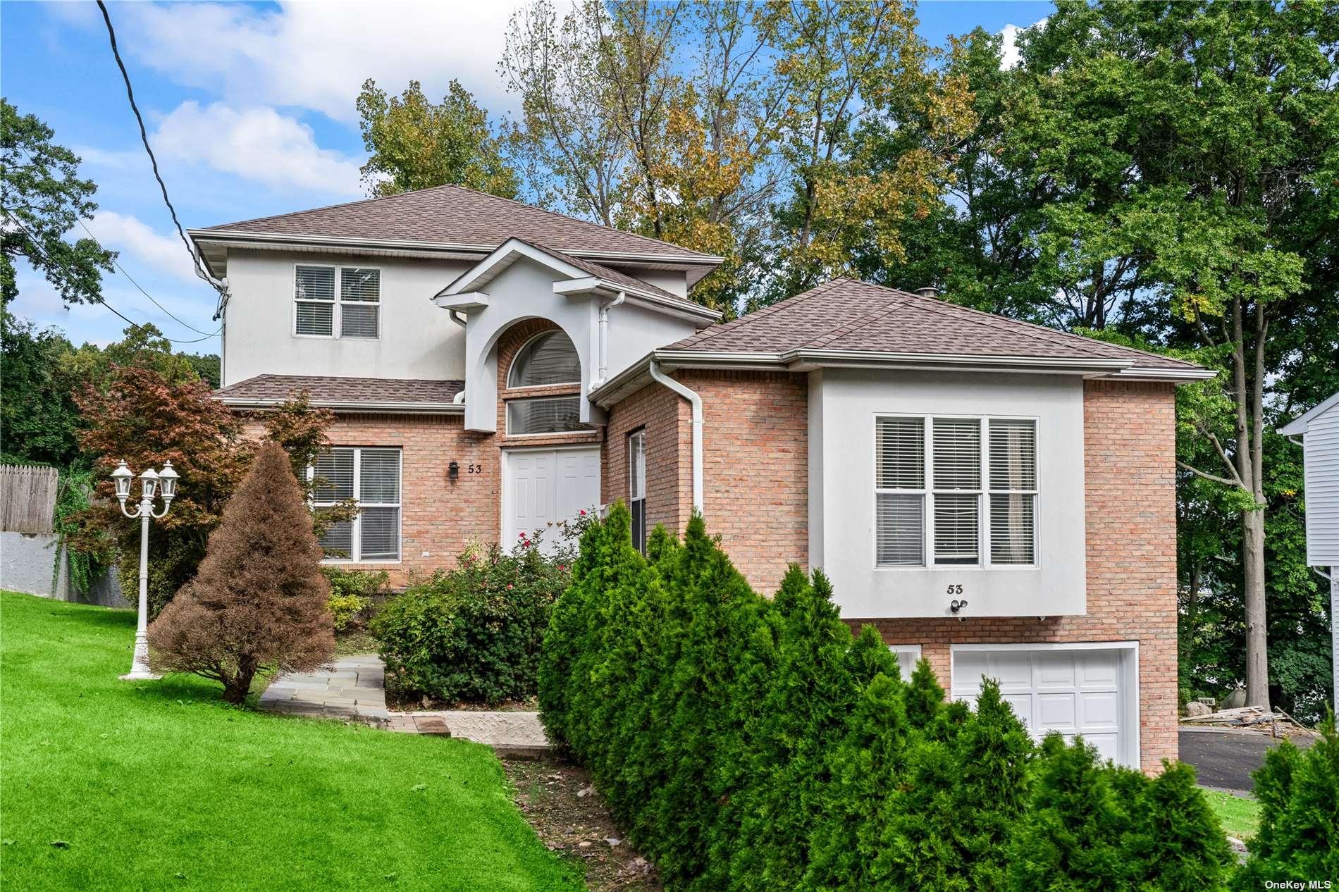 a front view of a house with a garden