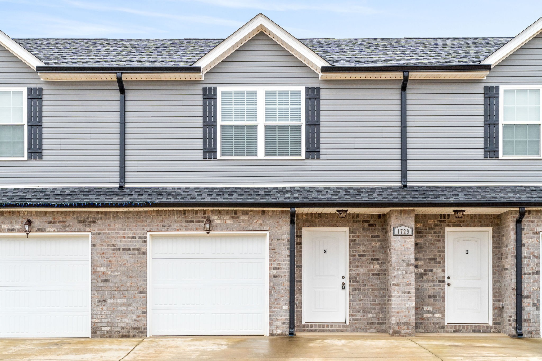 a front view of a house with garage