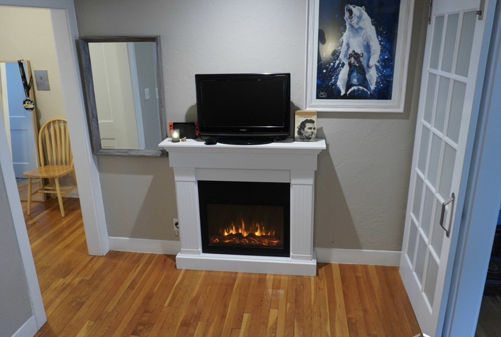 a living room with a fireplace and a flat screen tv