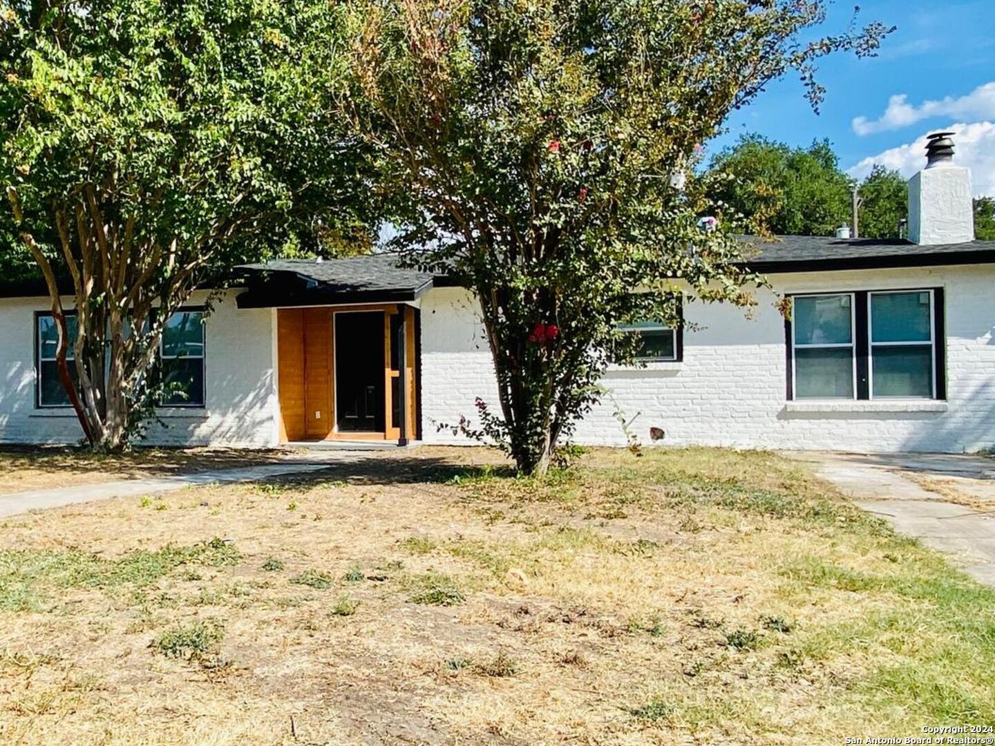 a house that has a tree in front of it