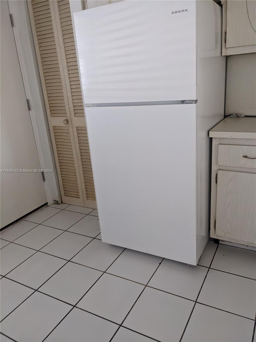 a view of a storage and utility room with washer and dryer