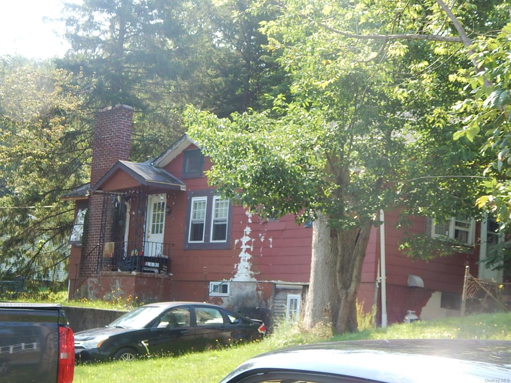 a front view of a house with a yard table and chairs