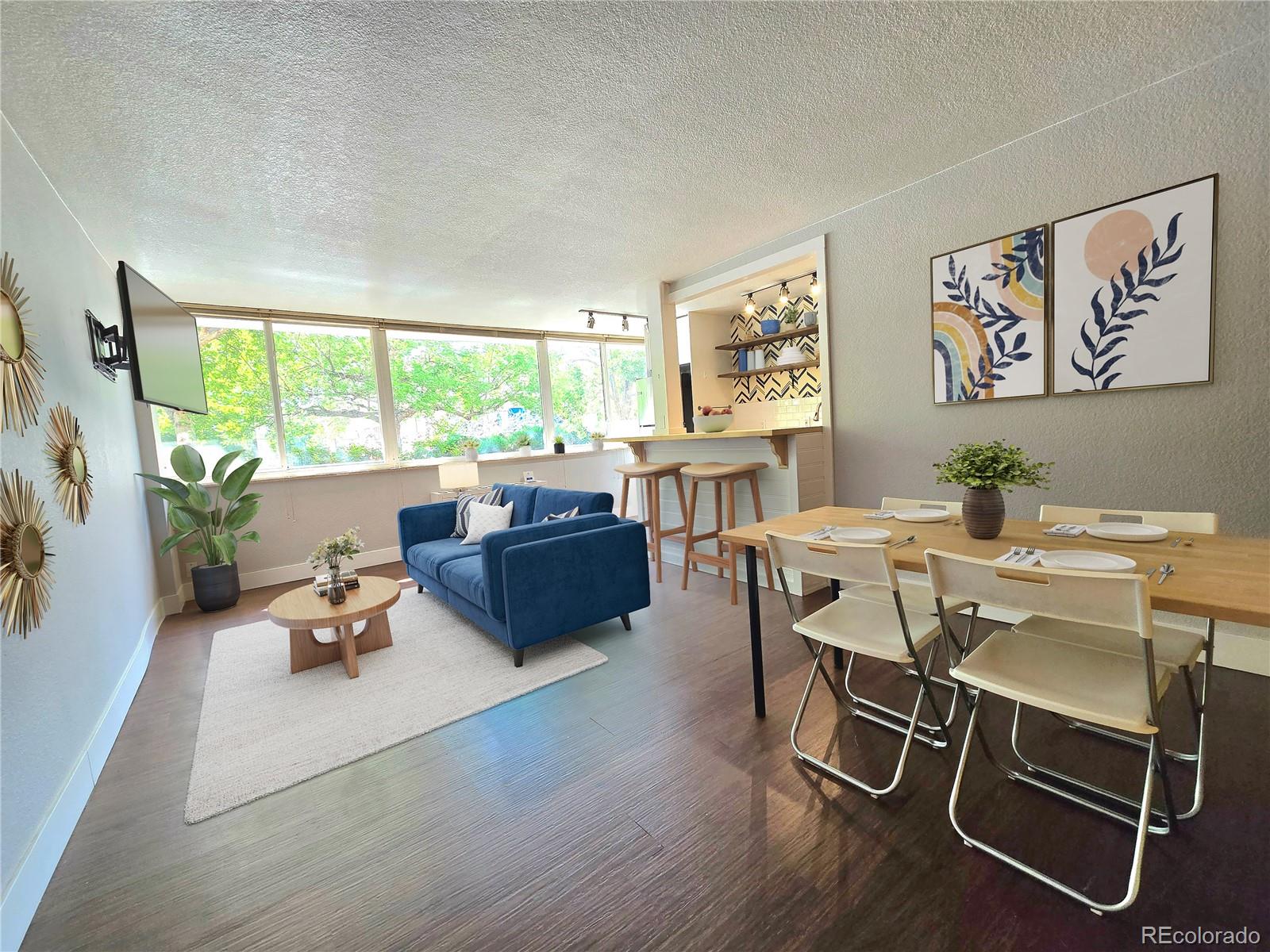 a room with a wooden table chairs and a large window