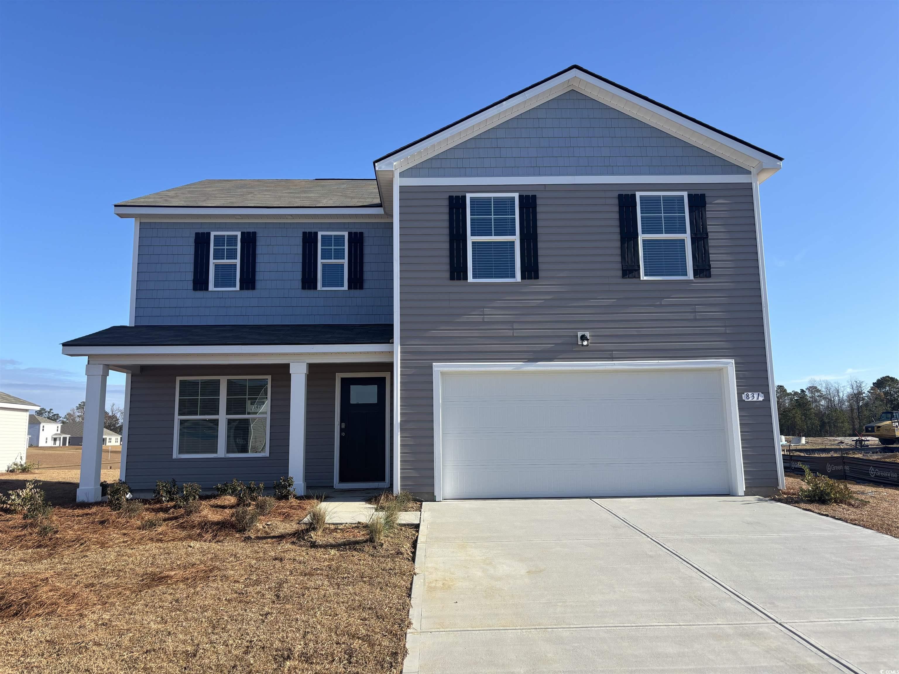 View of front of property featuring a garage